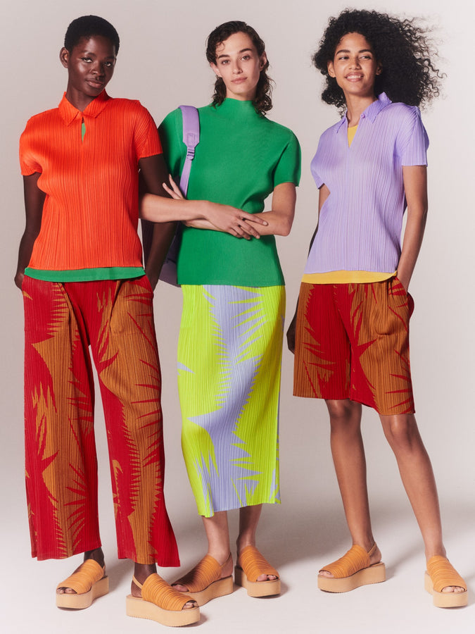 Three models wearing colourful PLEATS PLEASE ISSEY MIYAKE clothing.