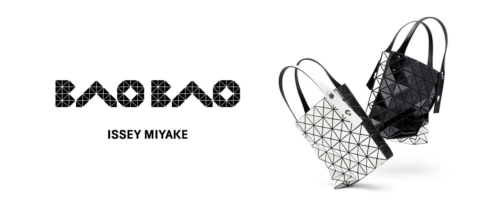 White background. Left: BAO BAO ISSEY MIYAKE logo in black. Right: Two "jumping" DUO tote bags in black and white. One has white side toward camera and the other has black.  