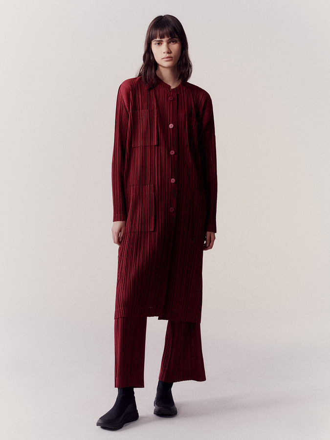RAMIE PLEATS Coat and Trousers in Carmine on model.