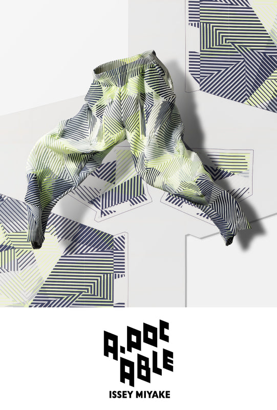 Top: Printed trousers in blue lime green and white stripes leaping across a background featuring the same print. Bottom: A-POC ABLE ISSEY MIYAKE logo in black on a white background.