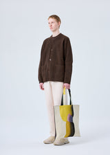 A model wears the HOMME PLISSÉ ISSEY MIYAKE RB_STYLO BILLE GOBELIN TOTE bag.