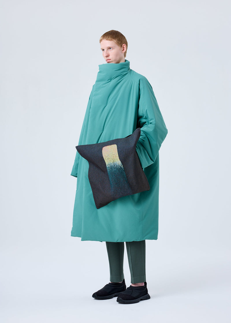 A model wears the HOMME PLISSÉ ISSEY MIYAKE RB_STYLO BILLE CUSHION COAT coat.