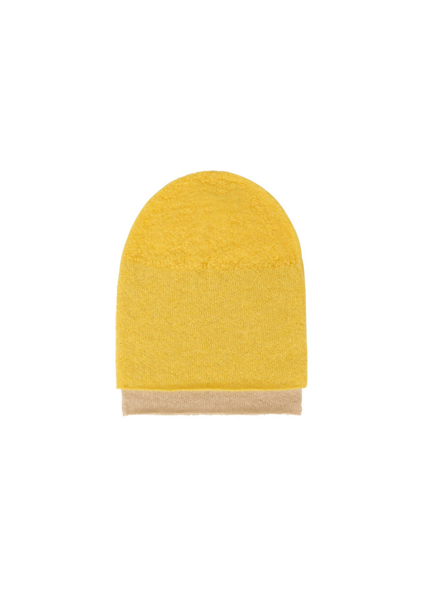 A product shot of the ISSEY MIYAKE INTERPLAY BEANIE hat in yellow-hued (57).