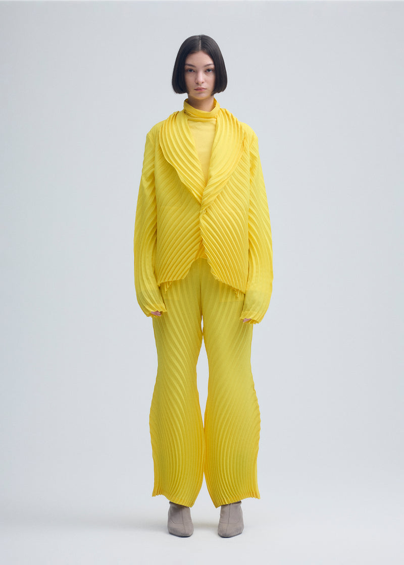 A model wears the ISSEY MIYAKE  WRAPPED PLEATS jacket