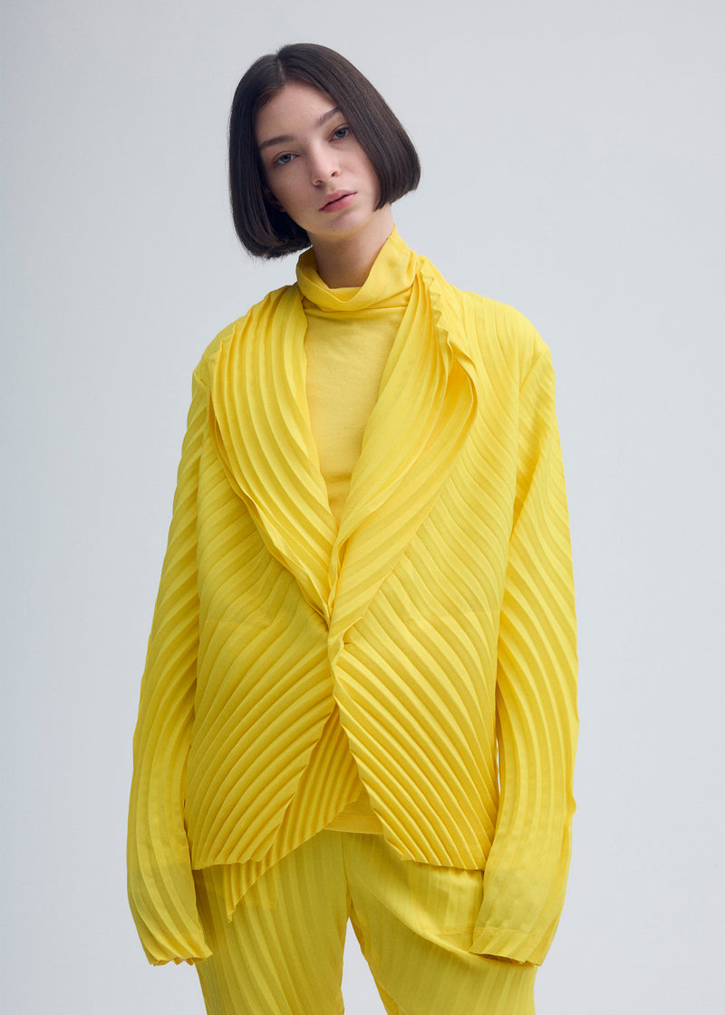 A model wears the ISSEY MIYAKE  WRAPPED PLEATS jacket