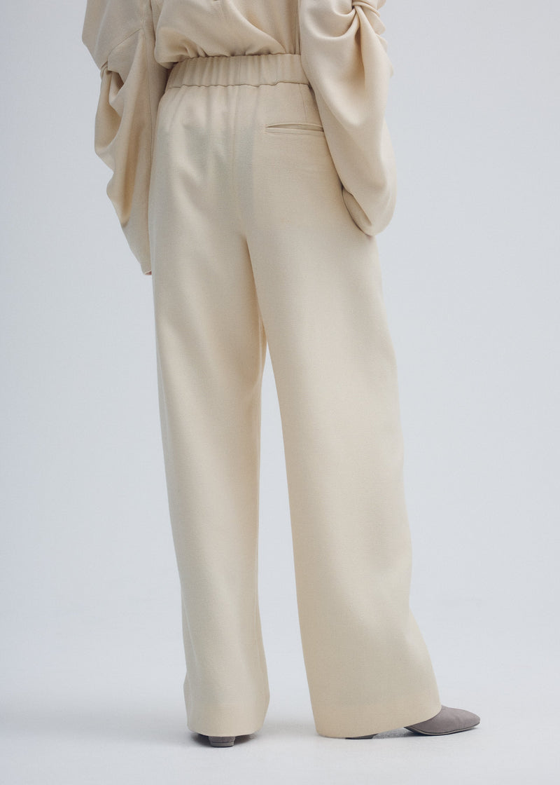 A model wears the ISSEY MIYAKE ENTWINE trousers.