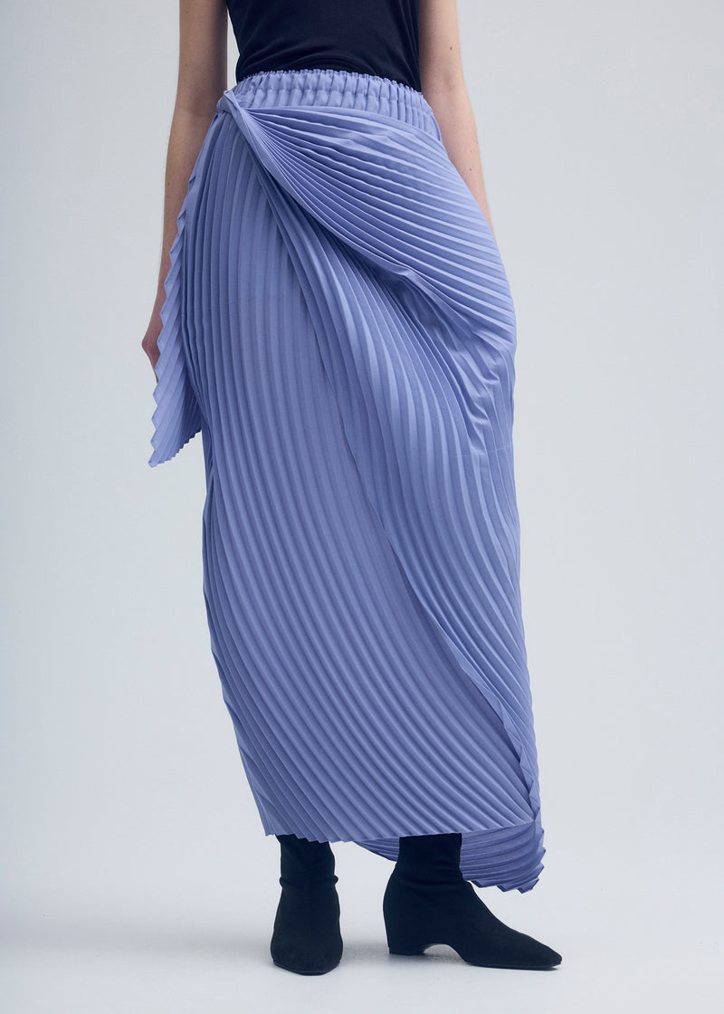 A model wears the ISSEY MIYAKE  WRAPPED PLEATS skirt