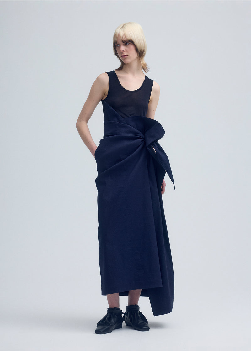 A model wears the ISSEY MIYAKE  ENCLOTHE skirt