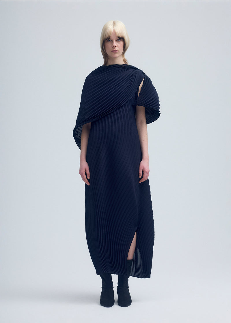 A model wears the ISSEY MIYAKE  WRAPPED PLEATS dress