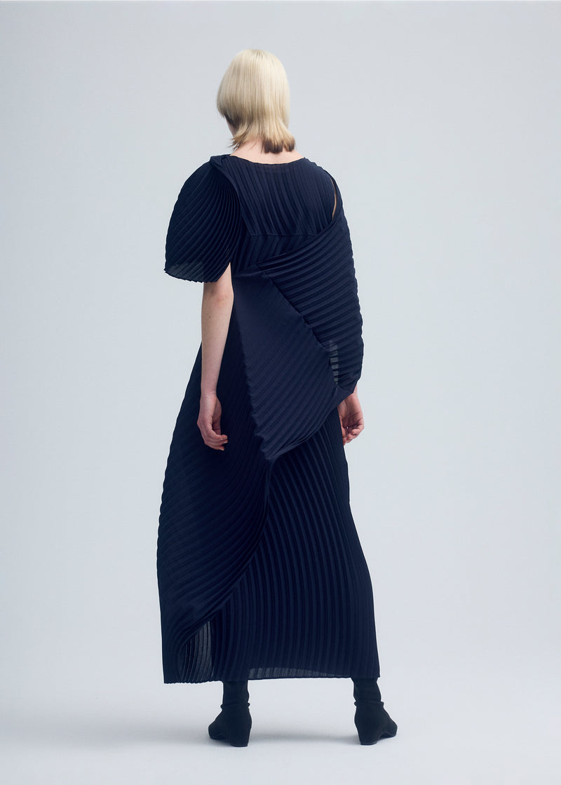 A model wears the ISSEY MIYAKE  WRAPPED PLEATS dress