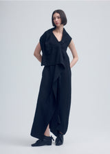 A model wears the ISSEY MIYAKE  ENCLOTHE PANTS jumpsuit