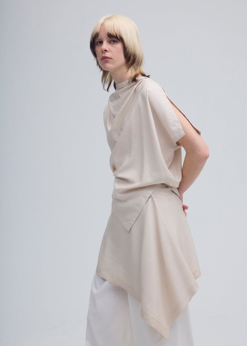 A model wears the ISSEY MIYAKE  ENCLOTHE SILK top