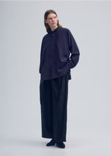 A model wears the ISSEY MIYAKE  ENCLOTHE SILK shirt