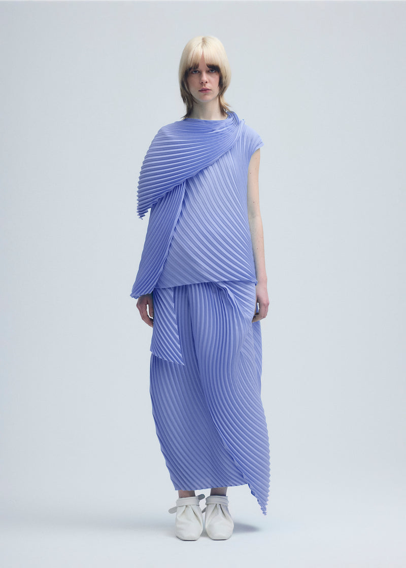 A model wears the ISSEY MIYAKE  WRAPPED PLEATS top