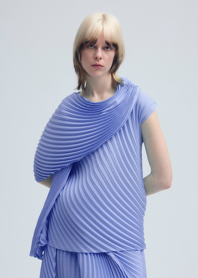 A model wears the ISSEY MIYAKE  WRAPPED PLEATS top