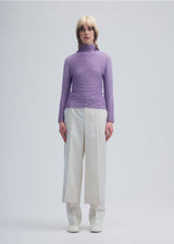 A model wears the ISSEY MIYAKE  WOOLY PLEATS 48 top