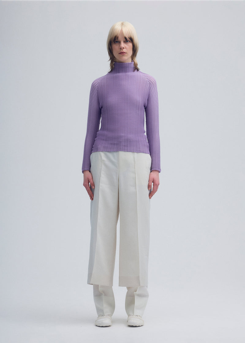 A model wears the ISSEY MIYAKE  WOOLY PLEATS 48 top