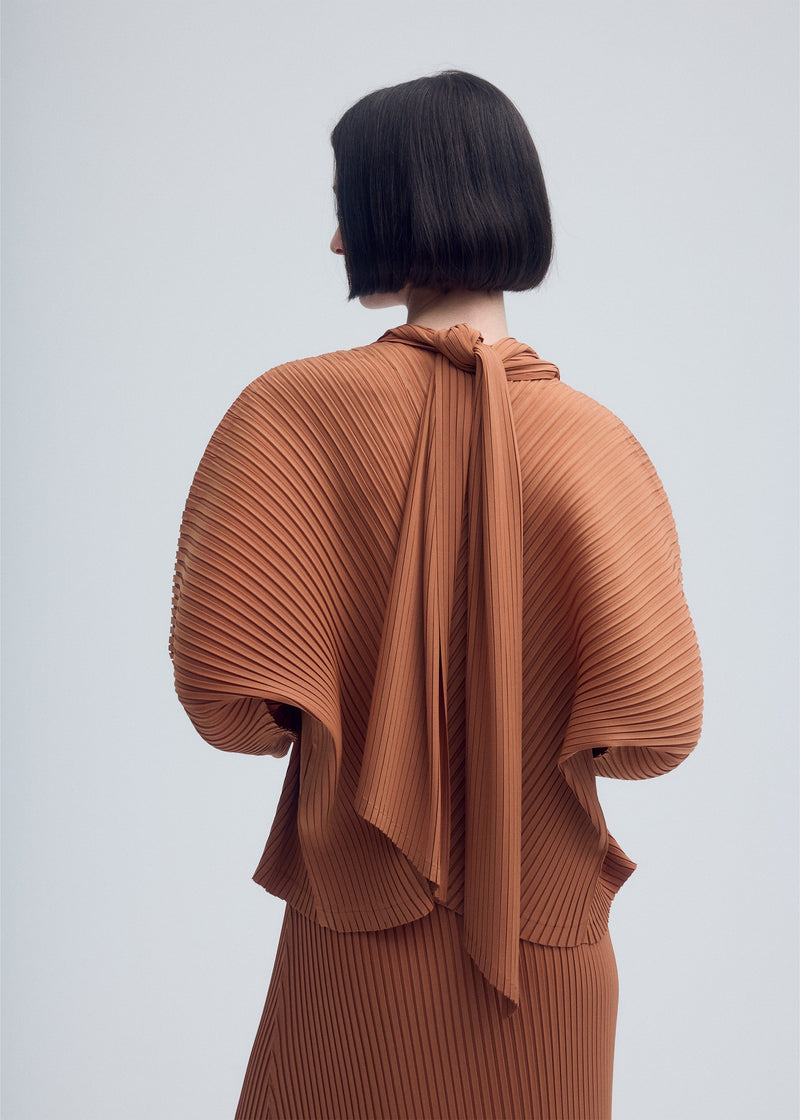 A model wears the ISSEY MIYAKE VIGOR PLEATS SOLID cardigan.