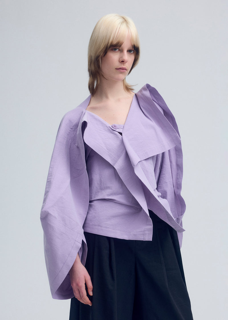 A model wears the ISSEY MIYAKE  ENCLOTHE cardigan