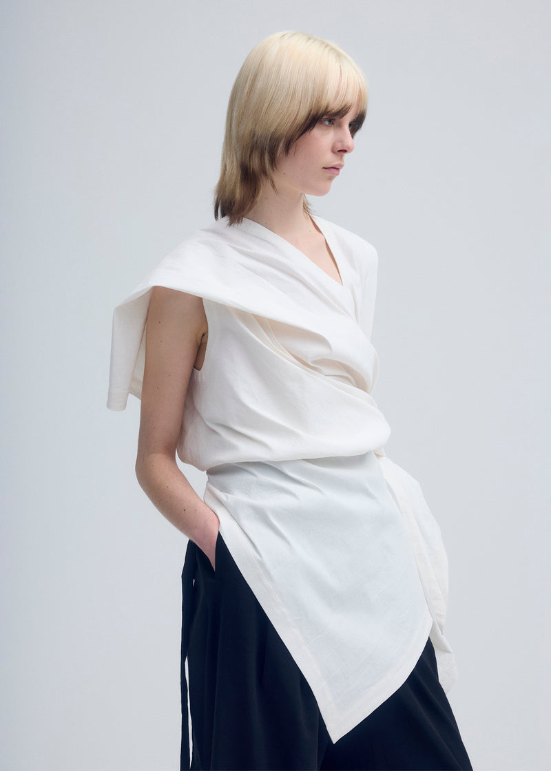 A model wears the ISSEY MIYAKE  ENCLOTHE tunic