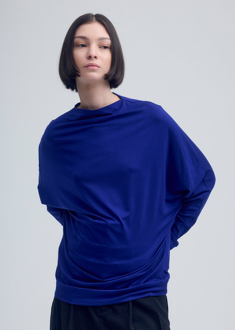 A model wears the ISSEY MIYAKE  WIND SMOOTH JERSEY top