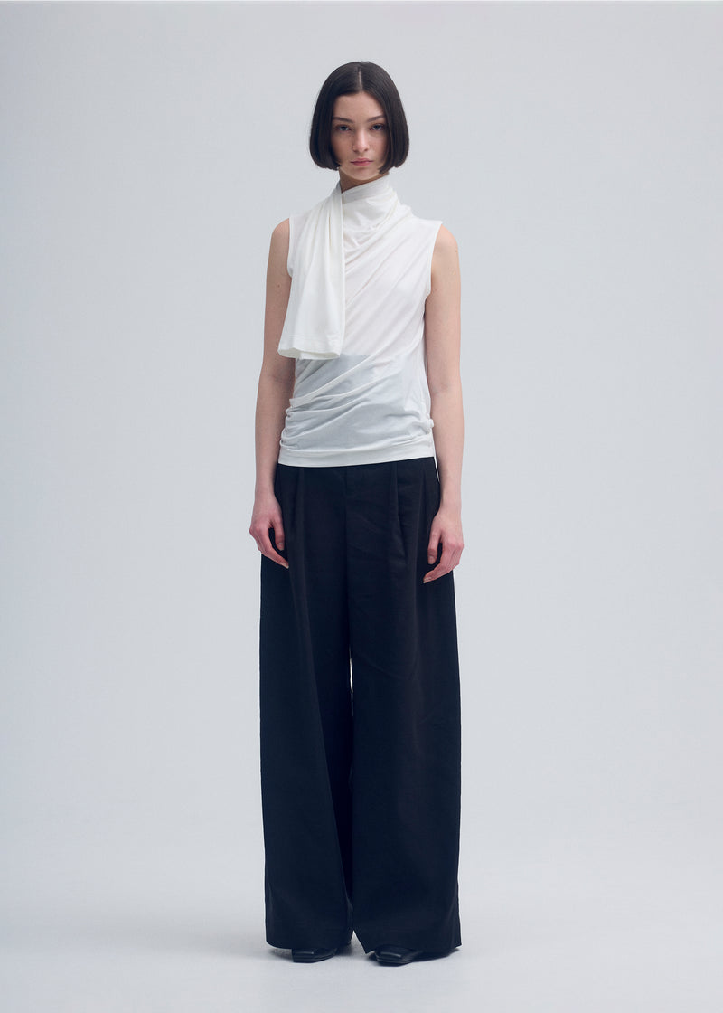 A model wears the ISSEY MIYAKE  WIND SMOOTH JERSEY top