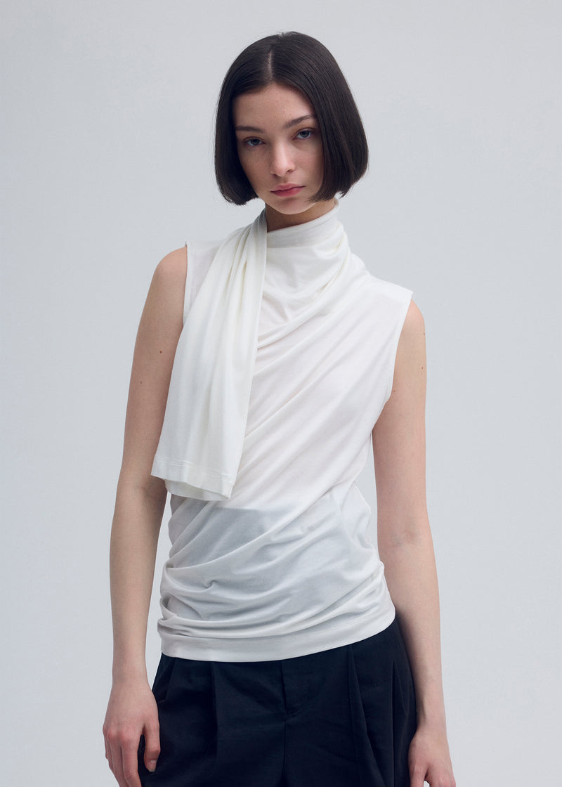 A model wears the ISSEY MIYAKE  WIND SMOOTH JERSEY top