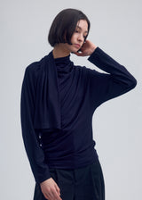 A model wears the ISSEY MIYAKE  WIND SMOOTH JERSEY top