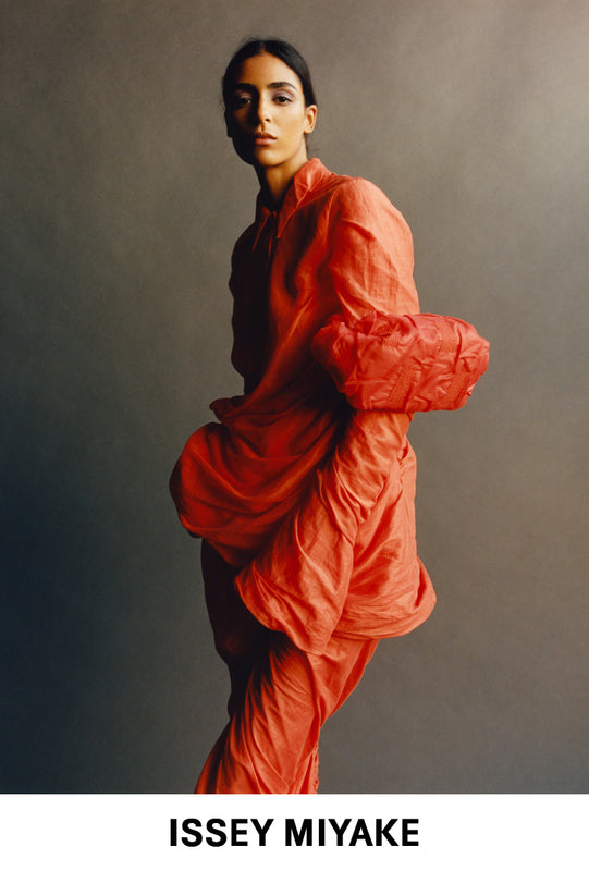 Model wearing TWINING shirt dress and trousers in ORANGE