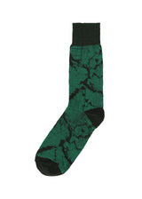 A product shot of the IM MEN SOMEWHERE SOCKS socks in green (62).