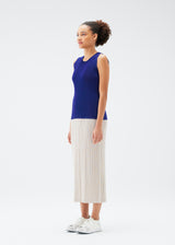 A model wears the PLEATS PLEASE ISSEY MIYAKE  MIST JULY top