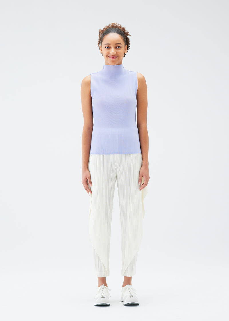 A model wears the PLEATS PLEASE ISSEY MIYAKE  MIST JULY top