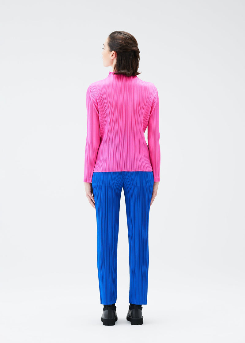 A model wears the PLEATS PLEASE ISSEY MIYAKE MONTHLY COLORS OCTOBER trousers.