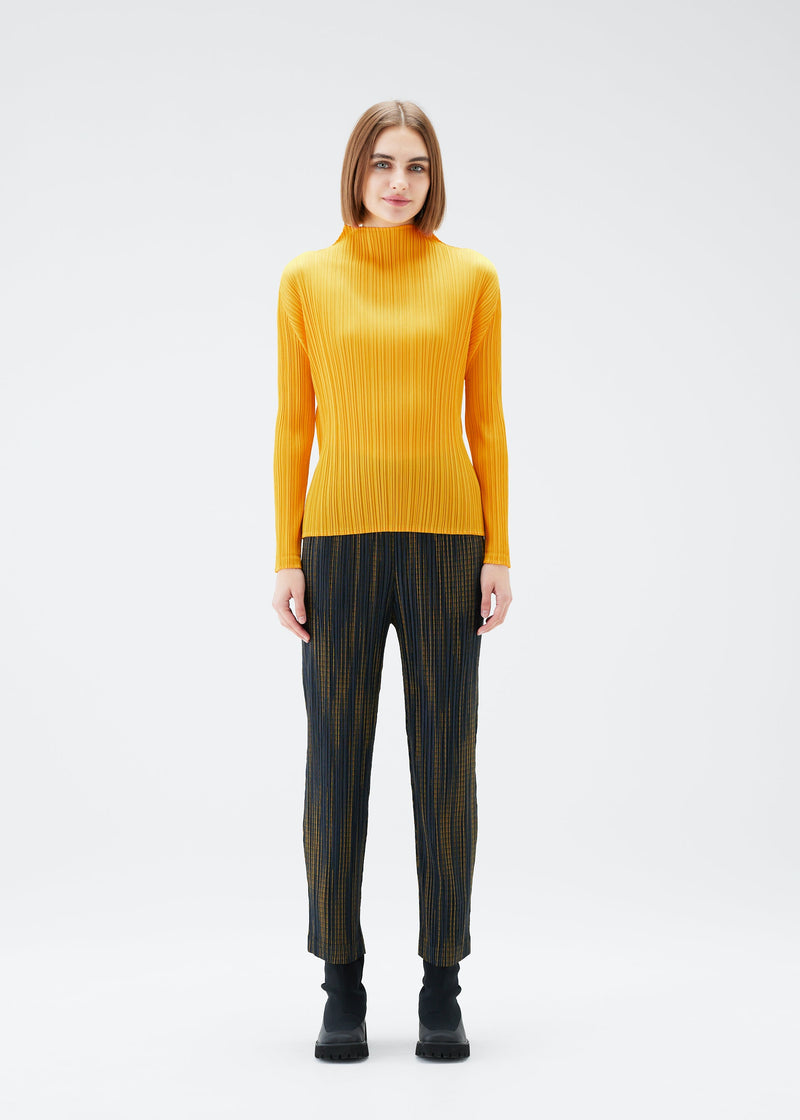 A model wears the PLEATS PLEASE ISSEY MIYAKE METEOR SHOWER trousers.