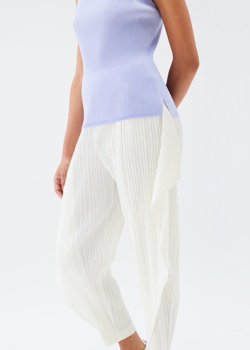 A model wears the PLEATS PLEASE ISSEY MIYAKE  THICKER BOTTOMS 1 trousers