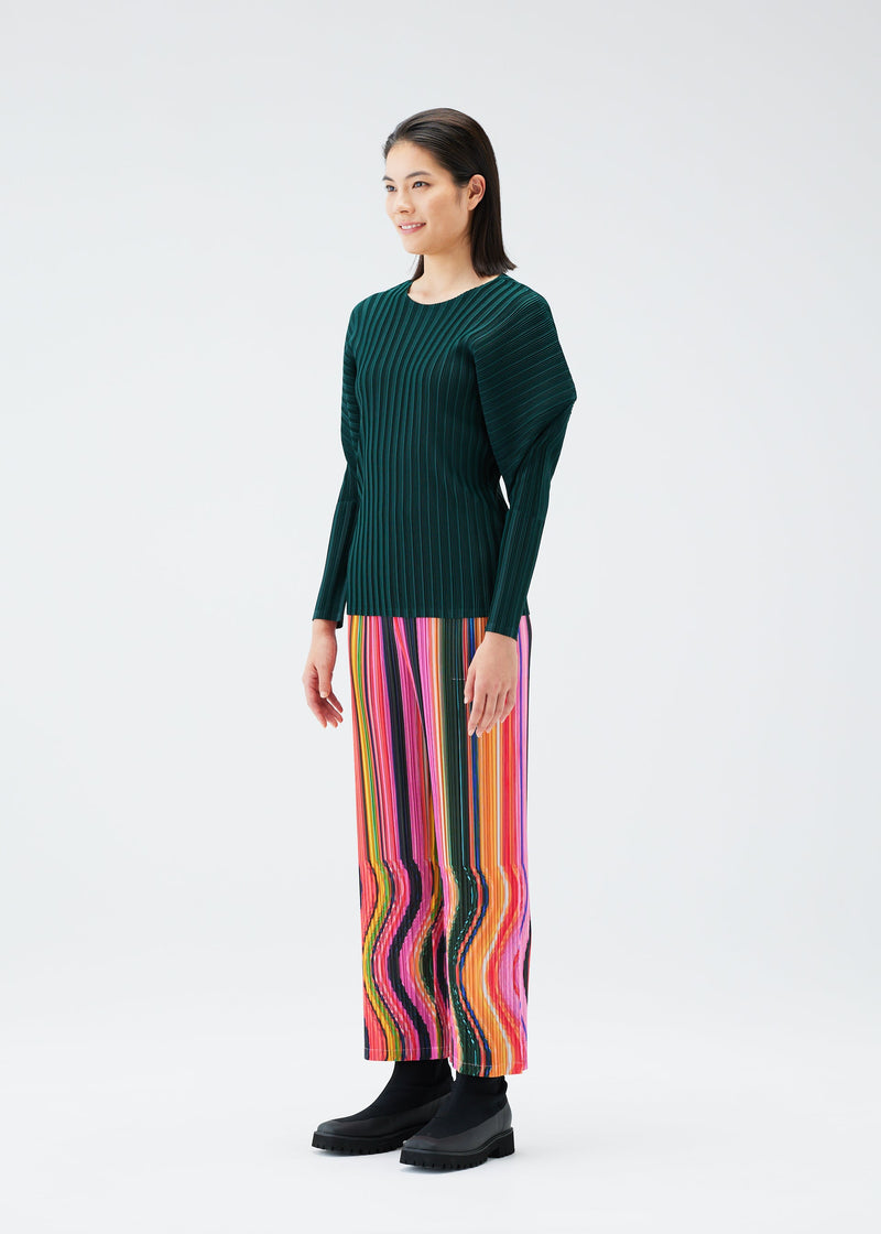 A model wears the PLEATS PLEASE ISSEY MIYAKE WARP trousers.