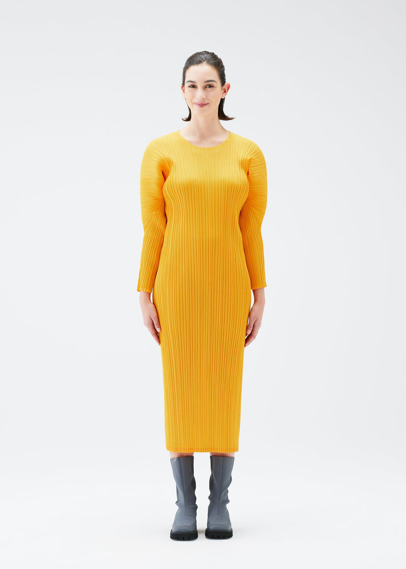 A model wears the PLEATS PLEASE ISSEY MIYAKE MONTHLY COLORS OCTOBER dress.