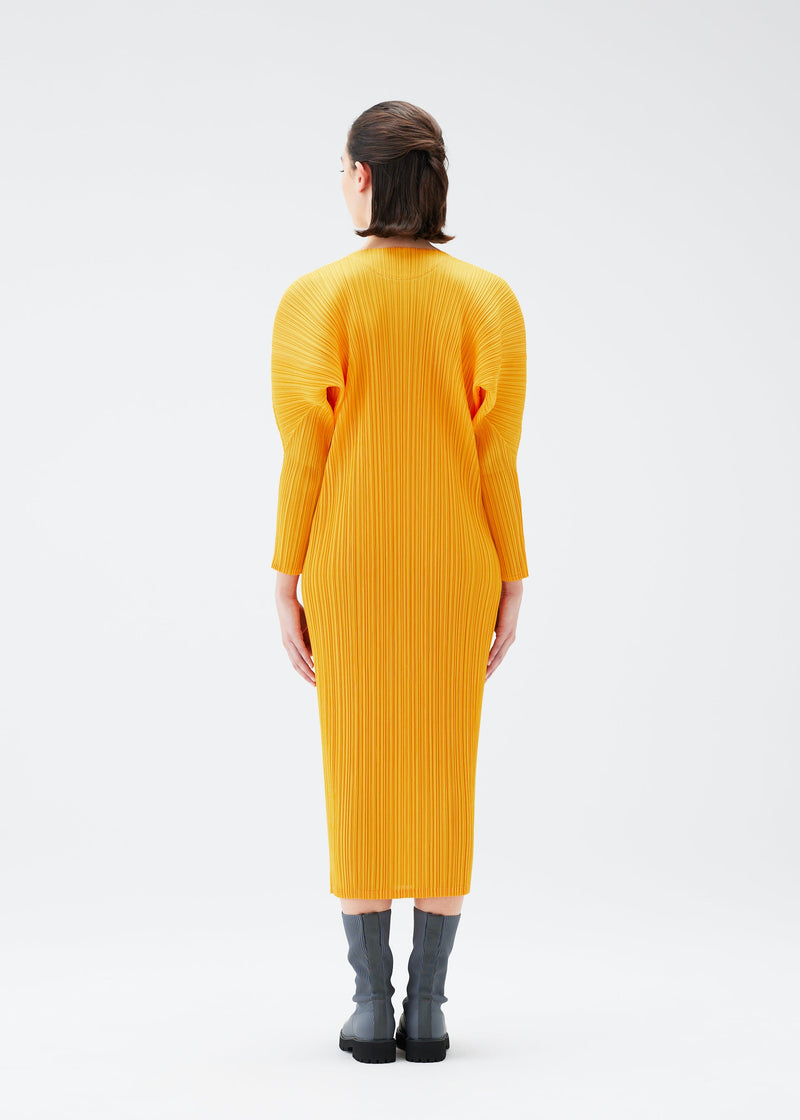 A model wears the PLEATS PLEASE ISSEY MIYAKE MONTHLY COLORS OCTOBER dress.