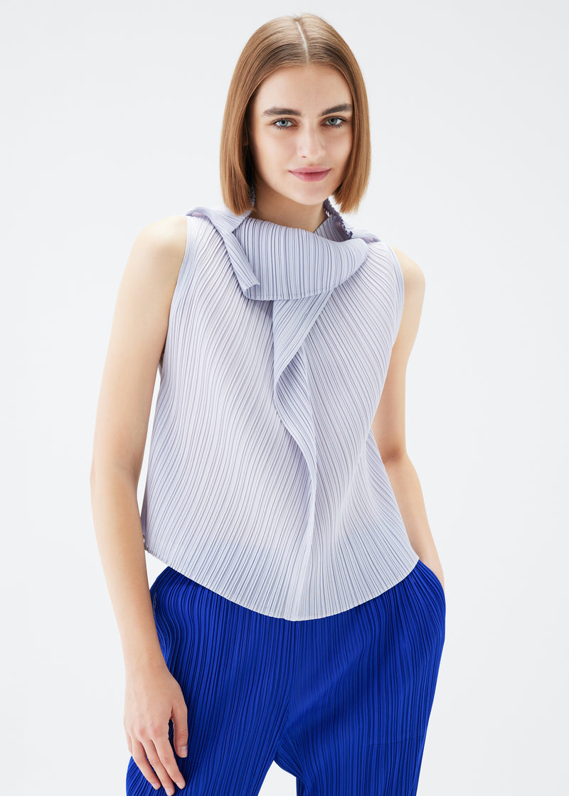 A model wears the PLEATS PLEASE ISSEY MIYAKE  MONTHLY COLORS JULY top