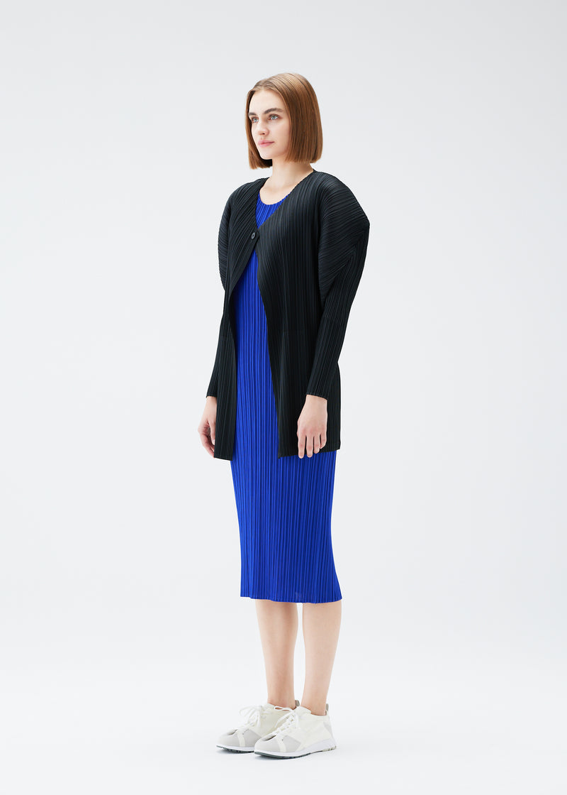 A model wears the PLEATS PLEASE ISSEY MIYAKE  MONTHLY COLORS JULY cardigan