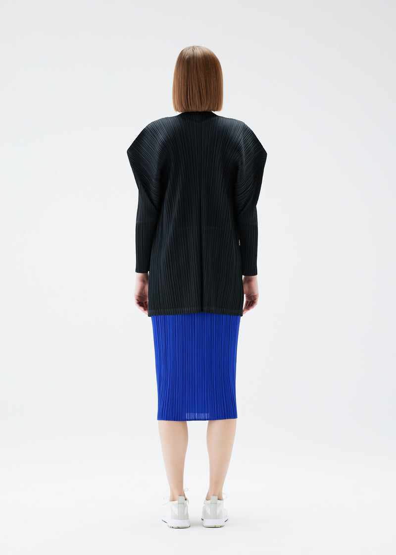 A model wears the PLEATS PLEASE ISSEY MIYAKE  MONTHLY COLORS JULY cardigan