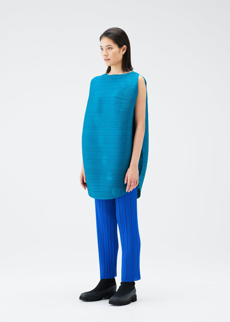 A model wears the PLEATS PLEASE ISSEY MIYAKE ORBIT tunic.