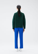 A model wears the PLEATS PLEASE ISSEY MIYAKE CREPE KNIT top.